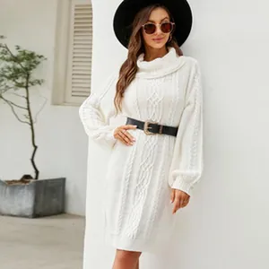 Detail view of a white cable knit sweater dress with batwing sleeves and high neck.