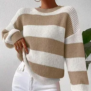 Close-up view of the khaki and white striped knit sweater on a model for autumn