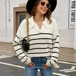 Casual white polo sweater with black horizontal stripes, styled in an urban street setting.