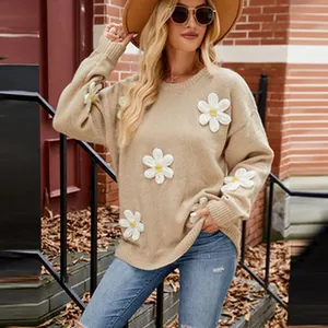Detailed shot of khaki knit sweater with white daisy flower appliques worn by a model