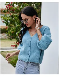 Close-up of light blue V-neck knit cardigan with puffed 3/4 sleeves and buttons.