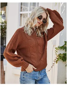 Detailed texture of burnt orange cable-knit sweater with a half-high neck design
