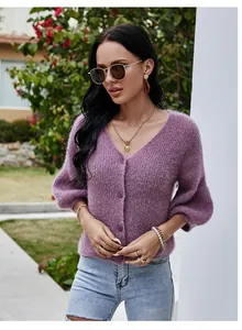 Close-up detail of a fuzzy purple V-neck knit cardigan with lantern sleeves