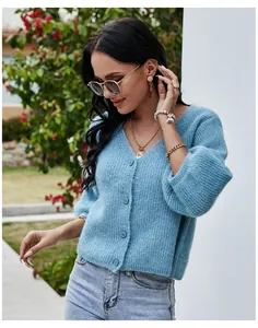 Model wearing a light blue V-neck knitted cardigan with fuzzy texture and buttons.