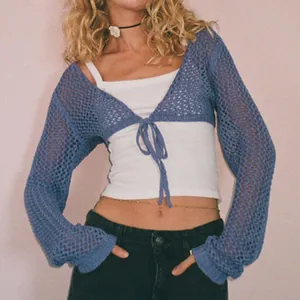 Detailed view of a stylish blue hollow-out knit bolero shrug with front tie closure.