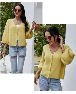 Macro view of a stylish yellow V-neck knit cardigan with three-quarter puff sleeves