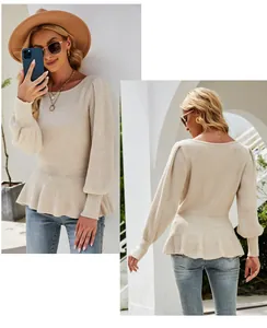 Detailed view of beige ribbed knit sweater with lantern sleeves and a flattering peplum hem.