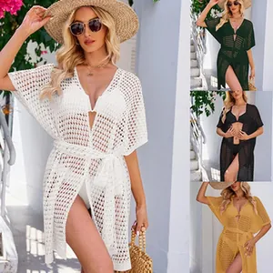Detailed view of hollow knit beach cover-up available in white, black, green and yellow.