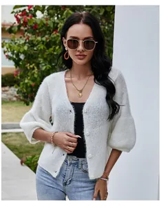 Close-up of white V-neck knit cardigan with soft fuzzy texture and stylish buttons