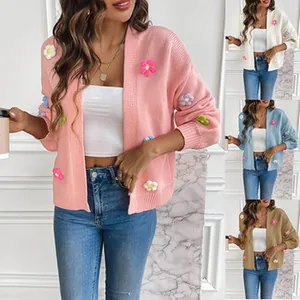 Women's knit cardigan with 3D floral appliques in multiple colors like pink and blue.