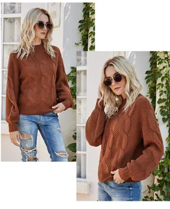 Detailed view of a brick-red cable-knit sweater with a semi-high collar and long sleeves.