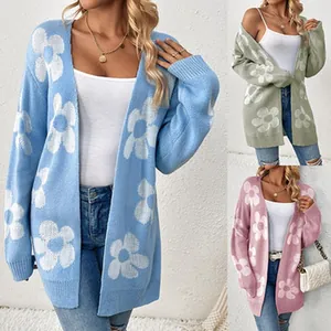 Close-up detail of knitted cardigan with large floral pattern in multiple colors