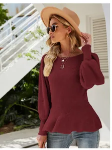 Detailed view of burgundy knit top with balloon sleeves and peplum waist design.