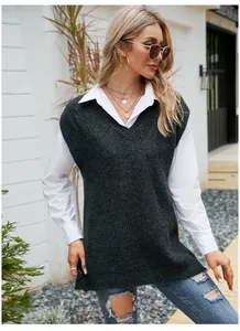 Outdoor lifestyle shot of a woman wearing a dark grey V-neck knit vest over a white shirt.