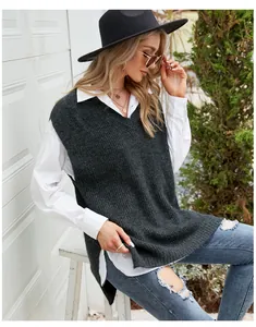 Detail showing casual charcoal grey V-neck knit vest with side slits over a white shirt