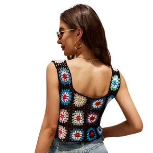 Hand-crocheted bohemian floral crop top with square neck and colorful granny square pattern.