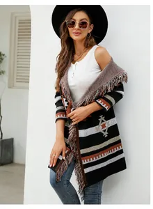 Detail view of a long hooded cardigan with geometric patterns and fringe detail