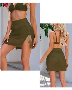 Detailed views showing the texture and drawstring of this green crochet mesh mini skirt.
