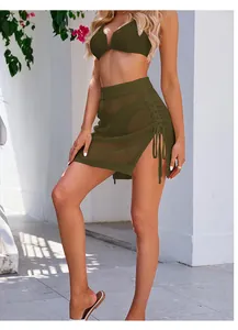 Detailed view of olive green crochet mesh mini skirt featuring side drawstring and slit design