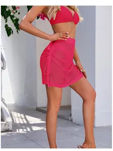 Side view detail of hot pink crochet mesh mini skirt featuring an adjustable drawstring side