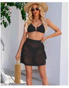 Macro view of black crochet mesh mini skirt with side slit and drawstring detail