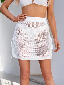Trendy sexy white crochet mesh mini skirt with drawstring sides for summer beach cover-up