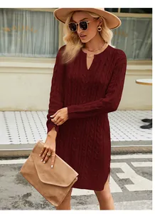Close-up detail of a burgundy cable knit sweater dress showing rich texture and notch neck