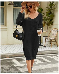 Elegant macro view of black cable-knit sweater dress shown in a stylish outdoor setting