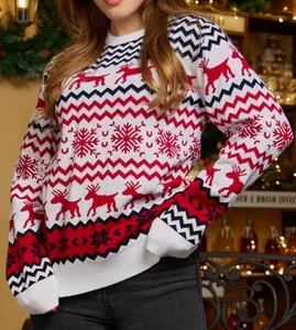 Detail shot of cozy Christmas knit sweater featuring reindeer and snowflake patterns.