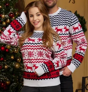 Close-up of festive Christmas couple sweaters featuring reindeer and snowflake patterns