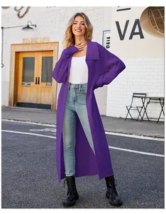 Full length shot of model wearing a long purple knit cardigan in a street setting