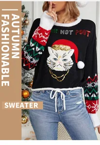 Close-up of cute kitten embroidery on a black Christmas pullover sweater with festive sleeves.