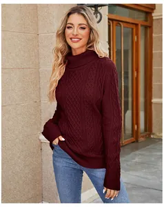 Close-up of women's burgundy turtleneck cable knit sweater in autumn street setting
