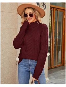 Woman wearing a stylish maroon cable-knit turtleneck sweater in an outdoor street setting