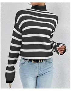 Detailed view of women's black and white striped turtleneck knit sweater in slim fit