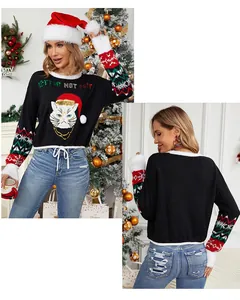 Close-up of black Christmas cat sweater with embroidery and festive sleeve patterns.