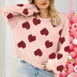 Close-up of pink puff sleeve knit sweater with red heart jacquard pattern