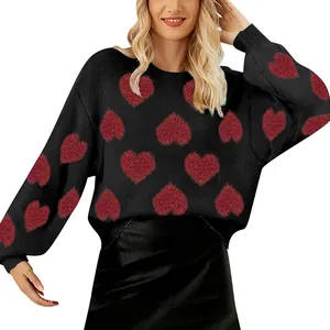 Detail view of women's Valentine's Day black knit sweater with red heart pattern