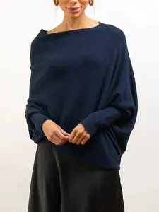 Close-up of a navy blue oversized batwing sleeve knitted sweater with boat neck detail