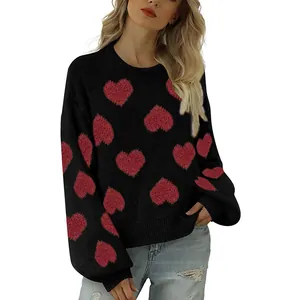 Detail of oversized black sweater featuring red fuzzy heart patterns and bubble sleeves.