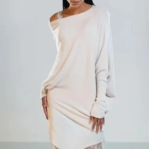Detailed view of an elegant cream off-shoulder knit sweater with batwing sleeves
