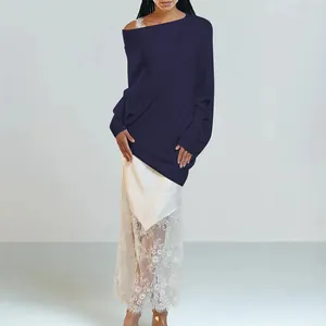 Detail of navy blue off-shoulder knit sweater with oversized batwing sleeves and loose fit.