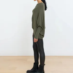 Side view of olive green boat neck knit sweater with batwing sleeves and fitted cuffs.