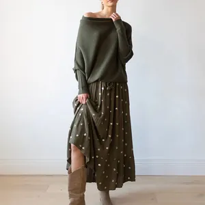 Detailed view of the olive green boat neck knit sweater with loose batwing sleeve fit
