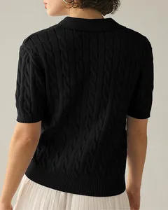 Back view detail of a black cable-knit short sleeve polo sweater with refined texture