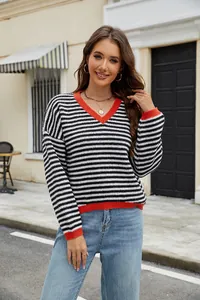Casual women's black and white striped V-neck knit sweater with vibrant red trim