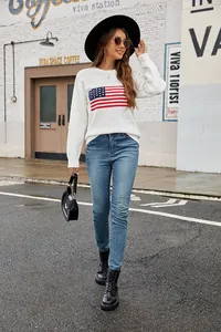 Stylish white round neck knit sweater with US flag pattern in an outdoor street setting