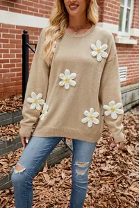 Detailed view of khaki oversized sweater with 3D white floral crochet appliqués