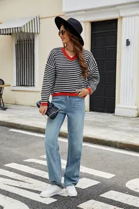 Full view of casual black and white striped V-neck sweater with vibrant red contrast trim