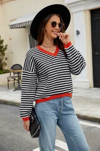 Detail shot of a stylish casual black and white striped sweater with red V-neckline